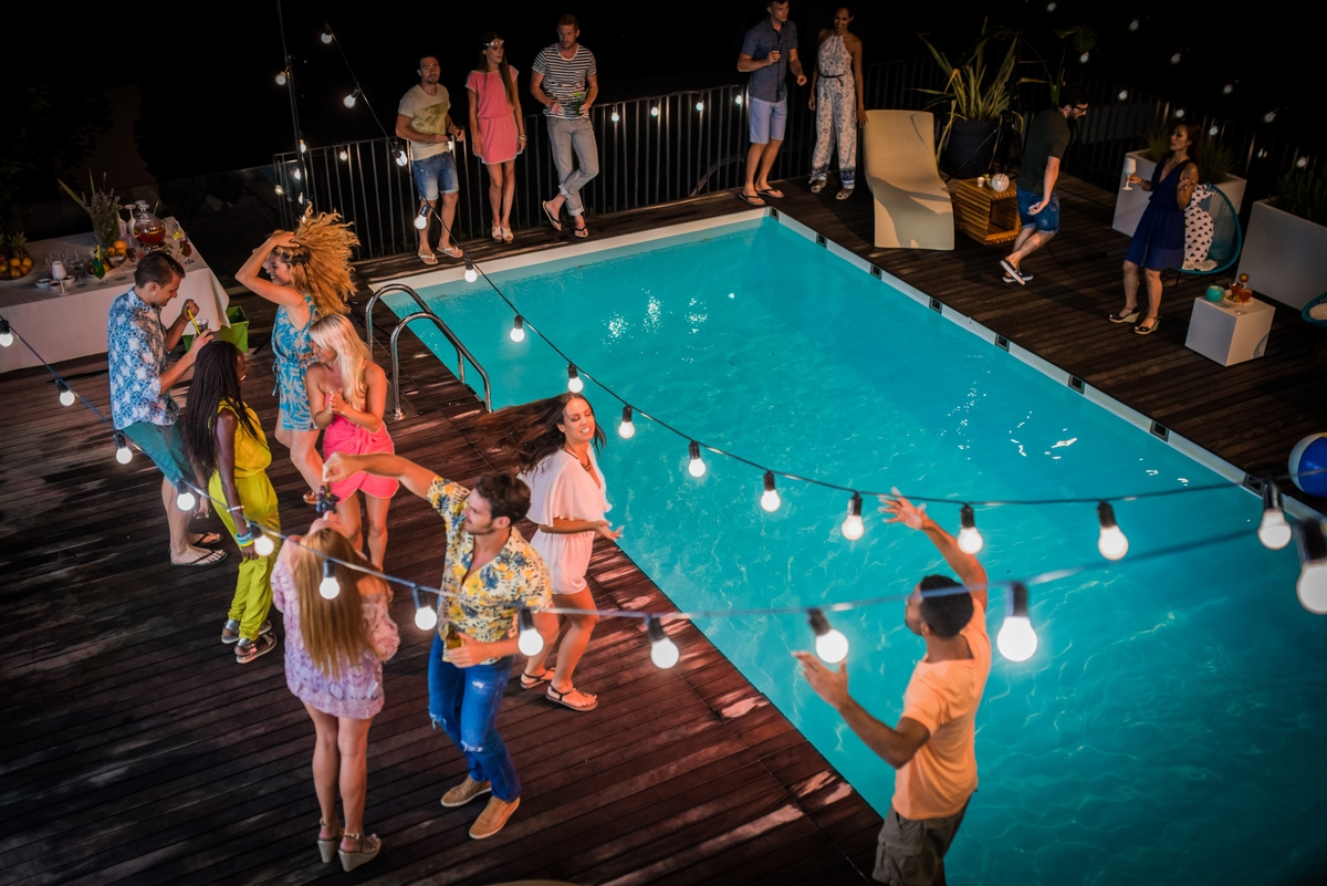 Poolside party with lights and guests